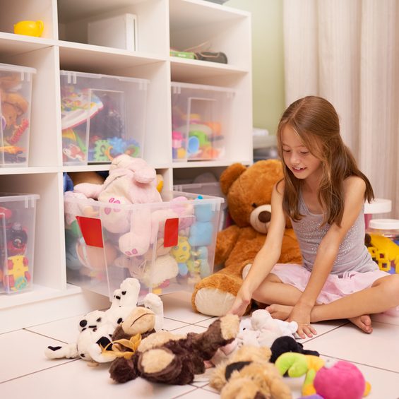 Shot of a young girl playing with toys in a room